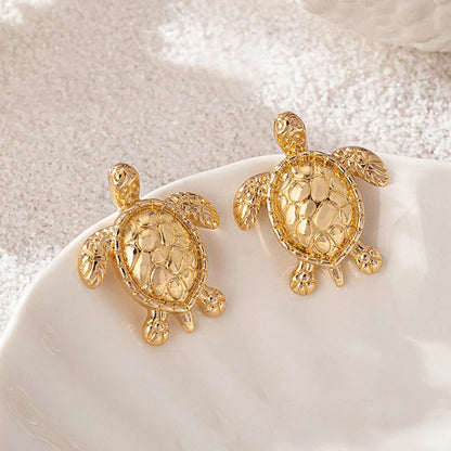 A pair of golden metallic animal turtle earrings