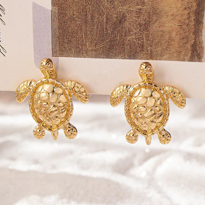 A pair of golden metallic animal turtle earrings