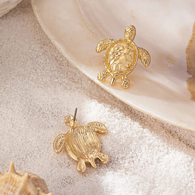 A pair of golden metallic animal turtle earrings